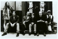 a group of people sitting on the steps of a building