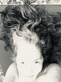 a woman laying on a yoga mat