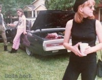 a group of people standing next to a car
